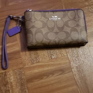 Coach wallet. Tan leather pattern. Purple fabric